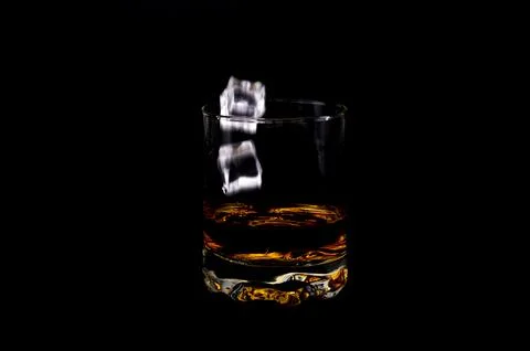 Whiskey with Ice Cubes Falling Stock Photos