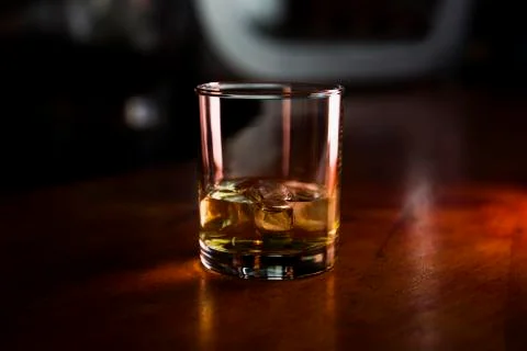 Whiskey With Ice Served in a Bar On a Rustic Wooden Surface Stock Photos