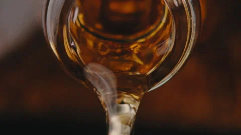 Whiskey poured out of bottle Stock Footage 274688756