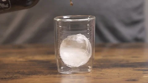 Whiskey poured over ice Stock Footage 127119254