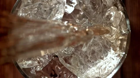 Whiskey Pouring over Ice Cubes into a Glass 库存影片 331102235