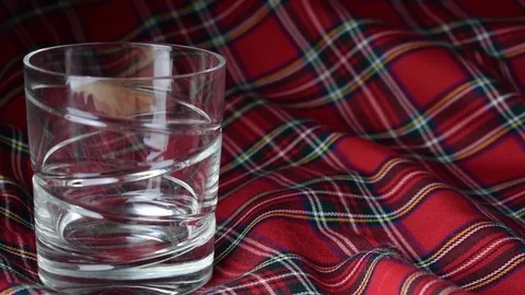 Whiskey Pouring with Tartan Background Stock Footage 71777002