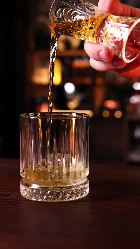 Whiskey pours into a glass Stock Footage 263185015