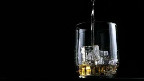 Whiskey on the rocks with a black background Video stock 167028574