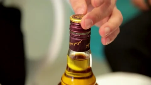 Whiskey, rum, cognac. Cropped image of a man's hand opening the cork of a bottle Stock Footage 170608053