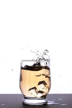 Whiskey with splashes in a glass Stock Photos