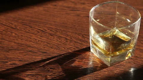 Whiskey is on the table - the man's hand taking a glass  HD Stock Footage 62983099