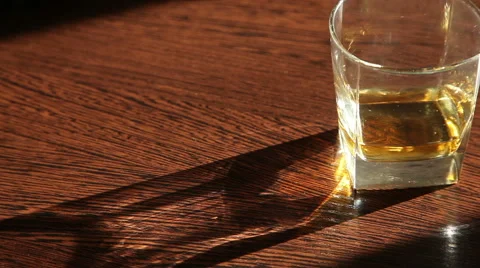 Whiskey is on the table - the man's hand taking a glass  HD Stock Footage 62983678