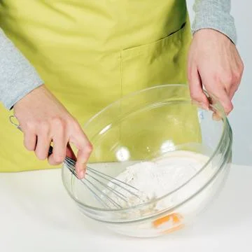 Whisking batter in kitchen Stock Photos