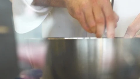 Whisking cake mixture inside a metal bowl at a restaurant kitchen Stock Footage 101217863