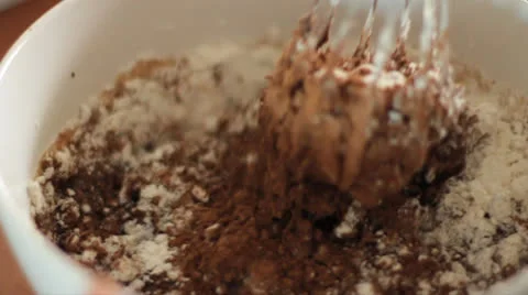 Whisking chocolate and flour Stock Footage
