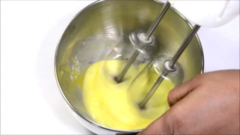 Whisking egg using electric beater Stock Footage 132867587