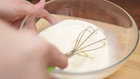 Whisking the eggs and skillfully transforming them into a fluffy omelette f.. Stock Footage 249384895