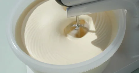 Whisking the eggs for sponge cake using electric mixer Stock Footage 130015466