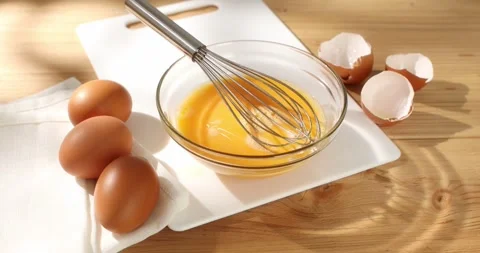 Whisking eggs. Whipped raw eggs in a bowl. Close -up. 4k footage. Stock Footage 242992000