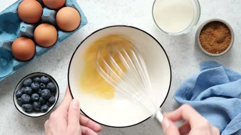 Whisking eggs with wire whisk Stock Footage 159592879