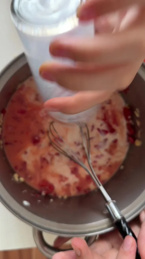 Whisking milk, eggs. diced tomato and cheese in pot, child’s hands close-up, no Stock Footage 337362338