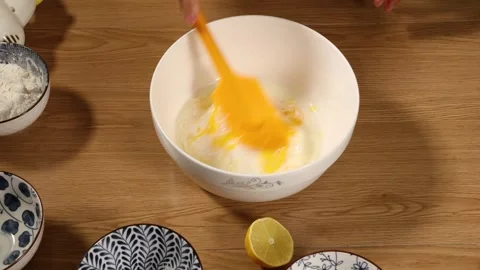 Whisking Raw Egg Yolk in White Ceramic Bowl Top Down View Stock Footage 340775352