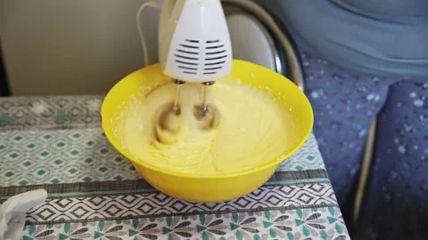 Whisking Thick Cake Batter with Electric Mixer in a Yellow Bowlv Vídeo Stock 332731966
