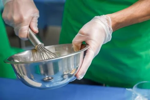 Whisking vigorously to disperse Stock Photos