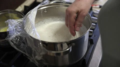 Whisking White Liquid Mixture in a Large Metal Pot on a Stove Vídeo Stock 332730078