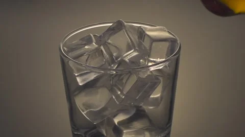 Whisky is poured over ice in slow motion; close up Stock Footage 55845762