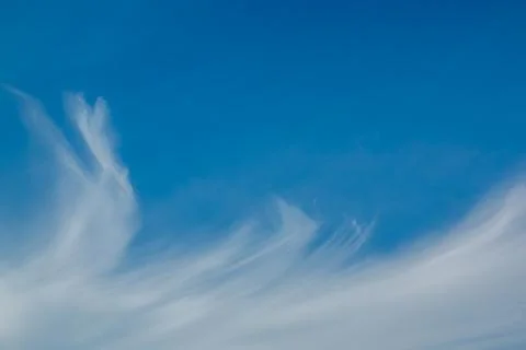 Whispy clouds on a blue sky. Stock Photos