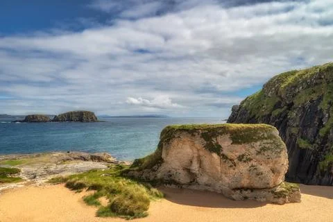 Whit rocks, cliffs and sandy beach at Ballintoy Harbour, Northern Ireland Stock Photos