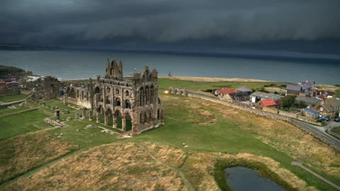 Whitby Abbey aerial view approaching a dramatic stormy sky Video stock 336803573