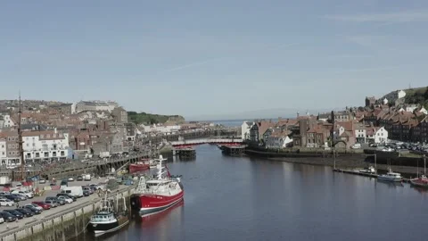 Whitby drone shot over River Esk approaching bridge and sea Stock Footage 239094190