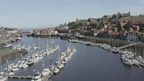 Whitby drone shot over River Esk approaching bridge and sea Stock Footage 239094677