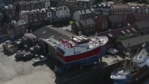 Whitby drone shot over River Esk approaching boatyard Stock Footage 240637172