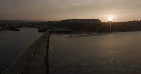 Whitby pier at sunset looking towards the town Stock Footage 240950706