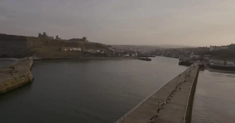 Whitby pier at sunset looking towards the town Stock Footage 240950712