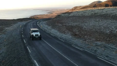 White 4wd Car on Empty Road in Wilderness of Iceland Passing Mountains on sha Stock Footage 158177138