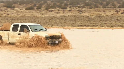 White 4x4 Splashing Through Mud - Shallow Depth of Field Stock Footage 107074510