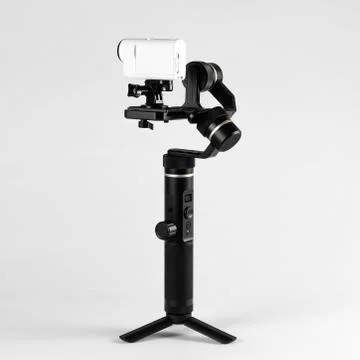 White action camera on three-axis stabilizer. Close up. Isolated on grey back Fotos Stock