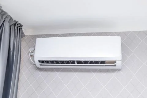 White Air Conditioner Mounted On The Wall Decorated With Wall Paper Inside The Stock Photos