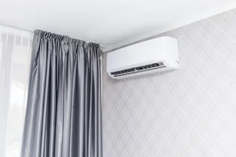 White Air Conditioner Mounted On Wall Decorated With Wall Paper Inside The Condo Stock Photos