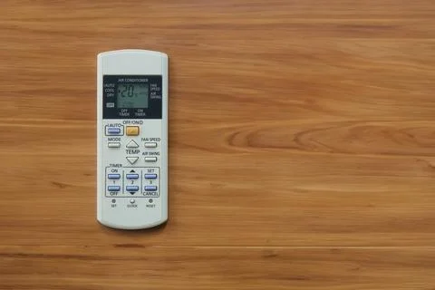 A white air conditioner remote control on a wooden table. with copy space Stock Photos