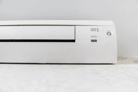 White air conditioner system on white wall in a room. Stock Photos
