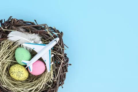 White airplane and easter egg nest flatlay Stock Photos