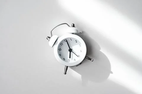  white alarm clock on a light background close-up Foto stock