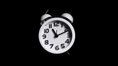 White alarm clock running timelapse time passing on isolated black backgrou.. Stock Footage 272760298