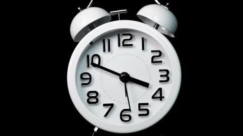 White alarm clock running timelapse time passing on isolated black backgrou.. Stock Footage 272760460