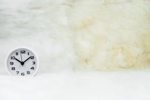 White alarm clock on table Stock Photos