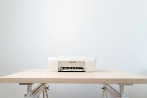 White All-in-One Printer On A Minimal Wooden Desk In A Clean Modern Office .. Stock Photos