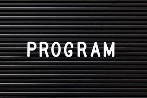 White alphabet in word program on black color felt letter board background Stock Photos
