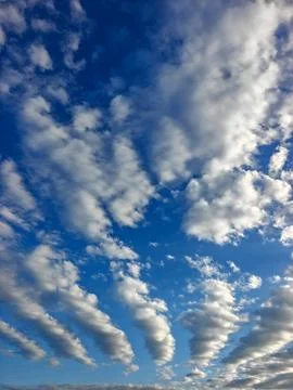 White Altocumulus Cloud Formations Against a Vibrant Blue Sky in Daylight Stock Photos