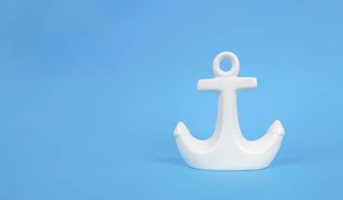 White anchor on a blue background. Copy space. Vacation concept. Stock Photos